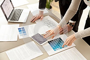 Interior designers teamwork with pantone swatch and building pla