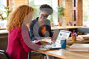 Interior designers using their laptops while contacting clients