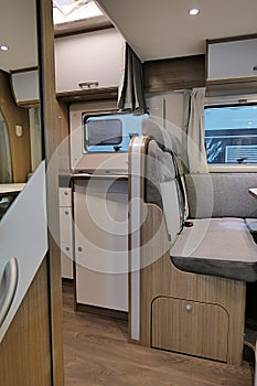 Interior detail of british Carado camper van - rear seats visible as well as various shelves and lockers.