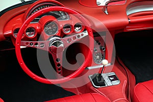 Interior details of red sports car steering wheel speedometer