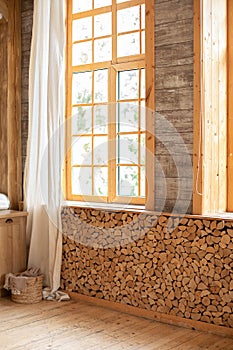 Interior eco room with wooden window with with White linen curtain and logs decoration wall on a sunny day indoor shot. Scandinavi