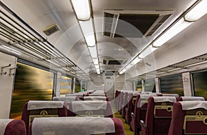 Interior of electric train with empty seats business transportation background.