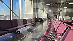 Interior of an empty airport terminal with seating rows