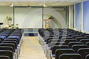 Interior of Empty Conference Hall With Lines of Blue Chairs in F