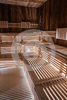 Interior of empty finnish sauna room with wooden wall and benches