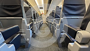 Interior of an empty first class cabin in a modern European train car.