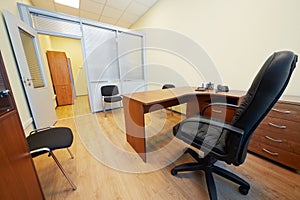 Interior of empty office cabinet with armchair