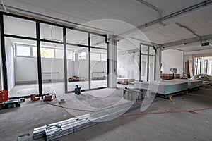 Interior empty office light room in a new building renovation or under construction. Glass doors and Windows