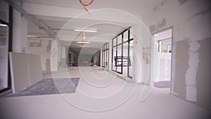 Interior empty office light room with white wallpaper without furniture in a new building renovation or under