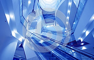 Interior of empty shopping mall toned in blue