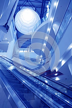 Interior of empty shopping mall toned in blue