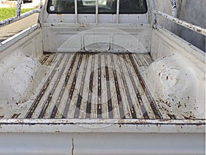 Interior of empty trunk of old and rusty vehicle. Back of empty rusty van. Rear view of empty rusty trunk on white Pick up