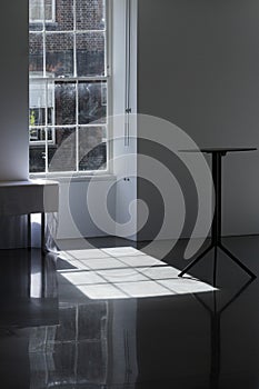 Interior of empty white hall with table