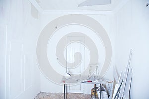 Interior with empty whiteboard, table with objects and other items