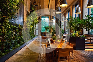 Interior fancy hotel lobby tables with vine covered walls in New York City