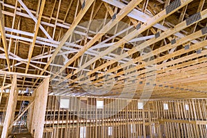 Interior framing of a new house under construction with roof trusses built frame