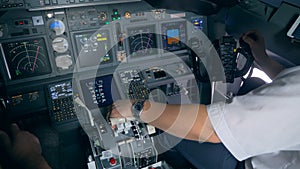 Interior of a functioning airplane cockpit with pilots sitting in it