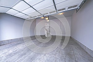 Interior of a garage with over the canopy garage door with window panels