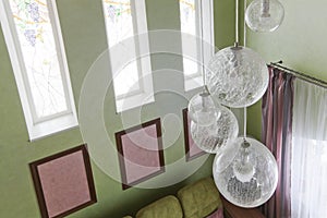 Interior in green colors and a glass chandelier