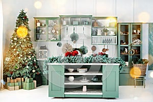 Interior of green kitchen with christmas decor, tree and christmas lights