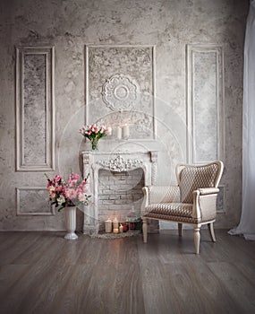Interior with grey fretwork background, fireplace and flowers