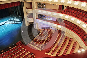 The interior of the hall with red chairs and stage