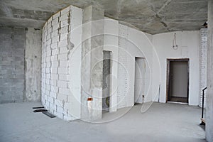 Interior hall room under construction, metal door lintels. Wall without plasterwork and ready to remodel