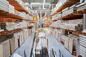 interior of hardware retailer with aisles, shelves, racks of building material insulation floor to ceiling. photo