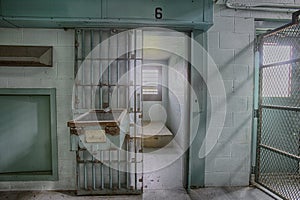 Empty high risk solitary confinement cell in abandoned prison photo