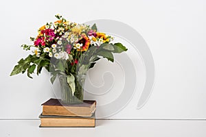 Interior home decor with flowers and books, simple summer decoration