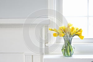 Interior Home decor of Yellow Daffodils on white mantle