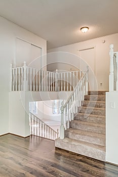Interior home stair case hard wood flooring white walls