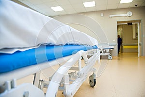 An interior of a hospital hallway with a stretchers