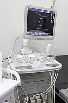 Interior of hospital room with ultrasound machine and bed