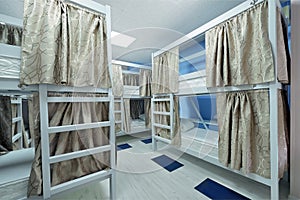 Interior of the hostel room. Bunk beds with fabric blinds