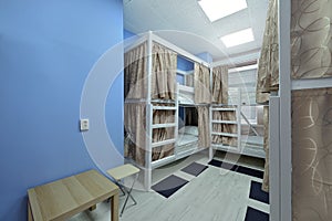 Interior of the hostel room. Bunk beds with fabric blinds