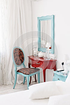 Interior hotel apartment, comfortable room, mirror and desk. folder for notes and lamp standing on a table in a hotel