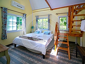 Interior of hotel resort with bed and wooden ladder