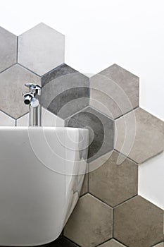 Interior of a house, private bathroom. hexagonal tiles with natural colors on gray brown in a bathroom. interior furnishings and