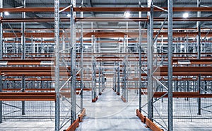 Interior of huge empty storehouse. Industrial warehouse racking.