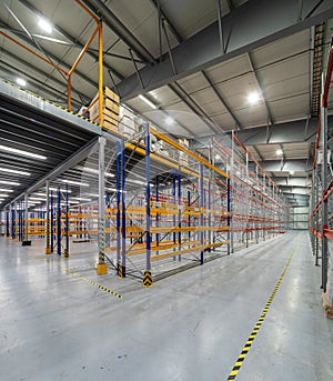 Interior of huge empty storehouse. Industrial warehouse racking.