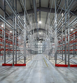 Interior of huge empty storehouse. Industrial warehouse racking.