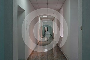 Interior of an identified building long white corridor