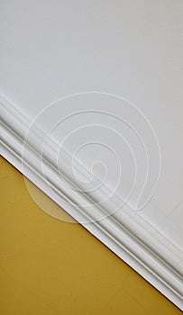 Interior image of diagonal white dado rail with yellow below and white above photo