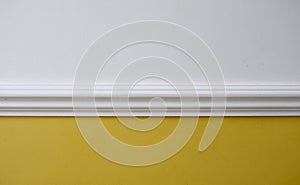 Interior image of white dado rail with yellow below and white above photo