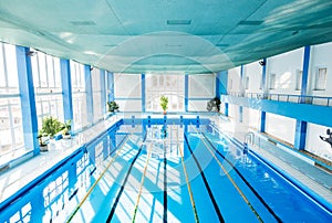 An interior of an indoor public swimming pool.