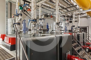 Interior of industrial gas boiler house with many pipes and boil