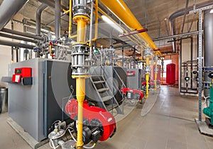 Interior of industrial, gas boiler room with boilers; pumps; sensors and a variety of pipelines