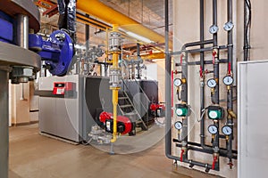 Interior of industrial, gas boiler room with boilers; pumps; sensors and a variety of pipelines