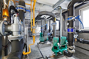 Interior of industrial, gas boiler room with boilers; pumps; sensors and a variety of pipelines